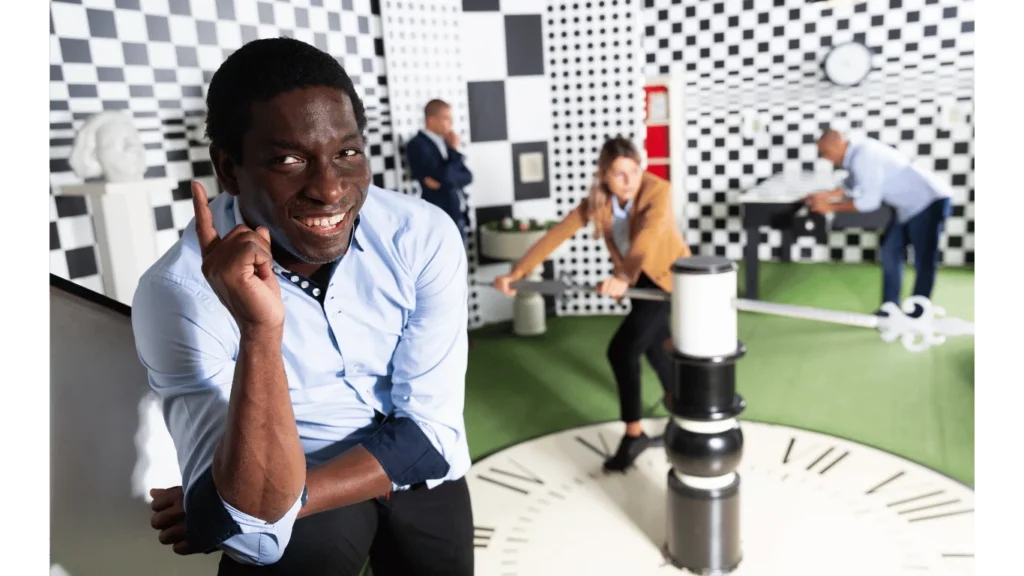 Escape room participants enjoying a challenging experience in a checkered, clock-themed setting, demonstrating teamwork and problem-solving skills at Think in a Box, San Angelo. Psychology of escape rooms