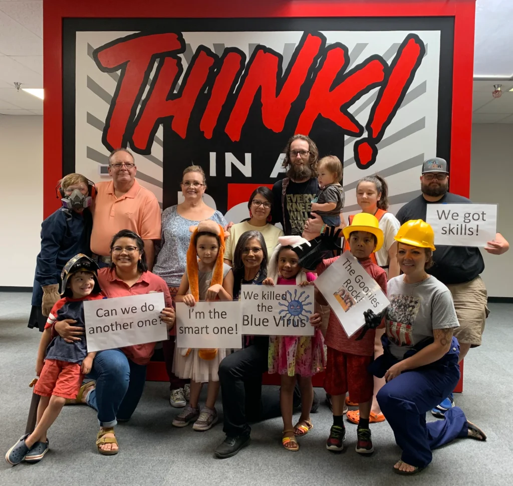 Large group of people posing for picture after finishing escape room at Think in a Box